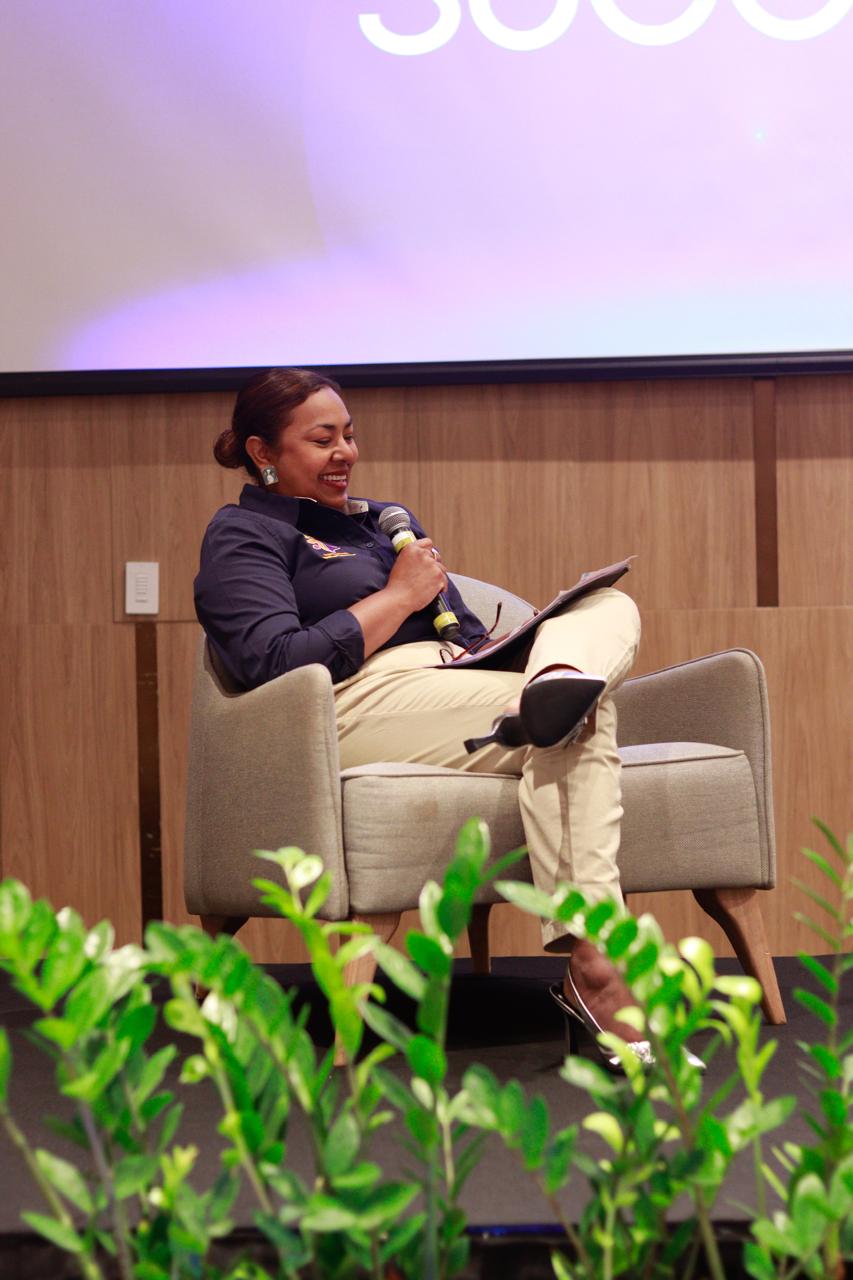Lady Life Insurance lead advisor seated with a microphone during a professional discussion